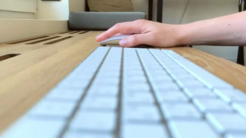 Side view of a hand moving a computer mouse. Keyboard positioned nearby dur.. Stock Footage 340284033