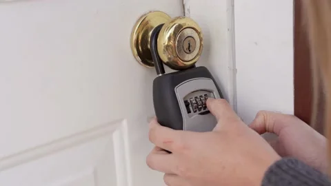 Side view hand opens key lockbox real estate Stock Footage 142984256