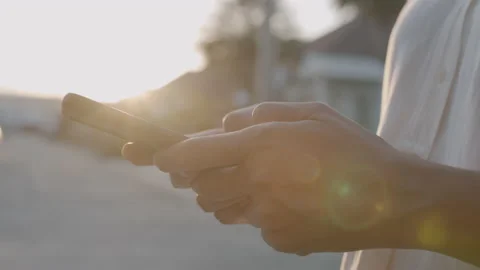 Side view. Hand of woman using smart phone on road in morning. Stock Footage 141798673