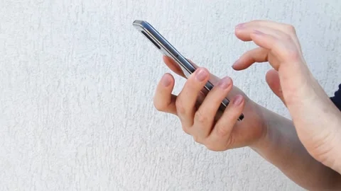 Side view. Hand of woman using smartphone on white background, typing message. Stock Footage 142509169