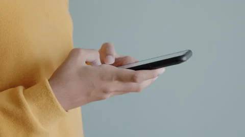 Side view of hand woman using smartphone or typing message Stock Footage 143958471