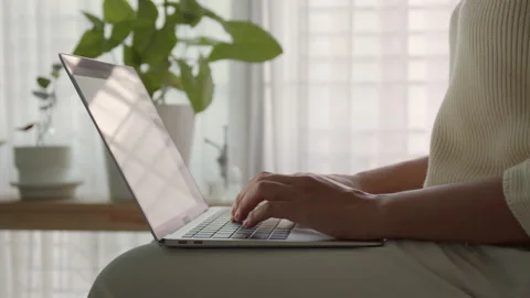 Side view. Hand of woman using a laptop, business typing work with computer Stock Footage 164203378