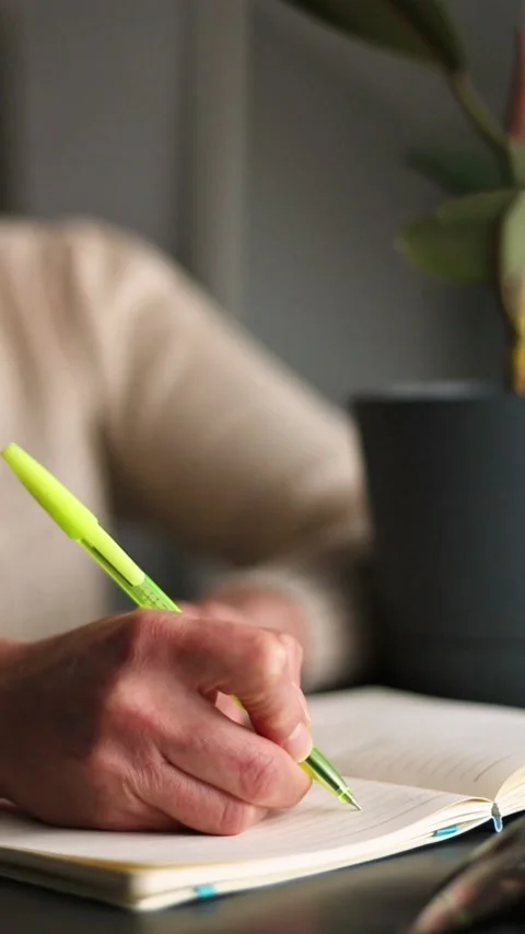 Side view of hand writing notes with pen in plain notebook. Minimalist Stock Footage 307751852