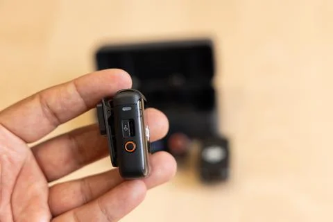 Side view of handheld DJI MIC 2 transmitter showing port and control button Stock Photos