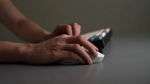 Side view of hands actively using wireless computer mouse and modern keyboard on Stock Footage 342760508
