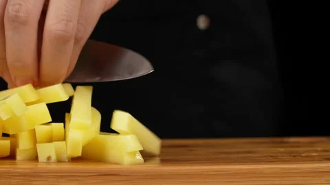 Side View of Hands Cutting Raw Potato into French Fry Sticks Stock Footage 343593386