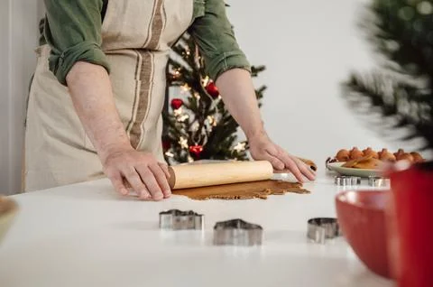 Side view on Hands of man preparing homemade gingerbread cookies for christmas Stock Photos