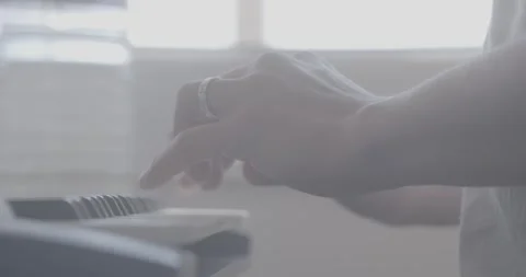 Side View Hands Playing Keyboard in Bright Light – 4K Ungraded Stock Footage 320104885