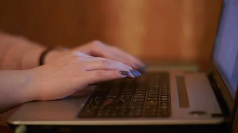 Side view of hands pressing the laptop keyboard.women's hands close-up.entering Stock Footage 132090311