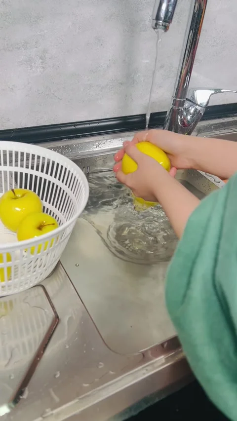 Side View of Hands Washing Fresh Yellow Apple under Running Tap Water Stock Footage 338162508