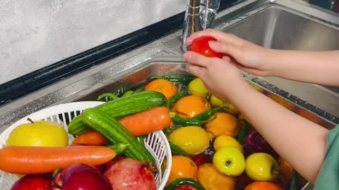 Side View of Hands Washing Mixed Fruits and Vegetables under Tap Water Stock Footage 338162276