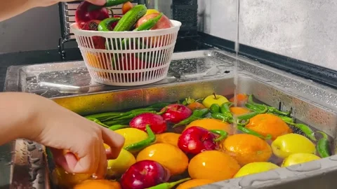 Side View of Hands Washing Mixed Fruits and Vegetables under Tap Water Stock Footage 338162767