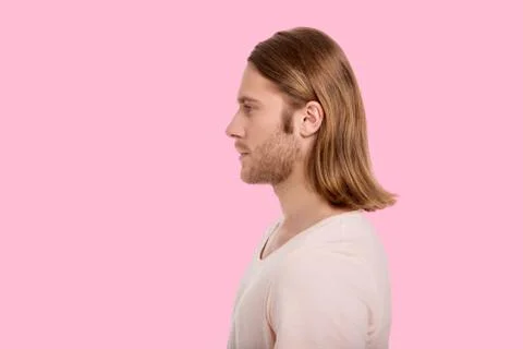 Side view of handsome man against pink background Stock Photos