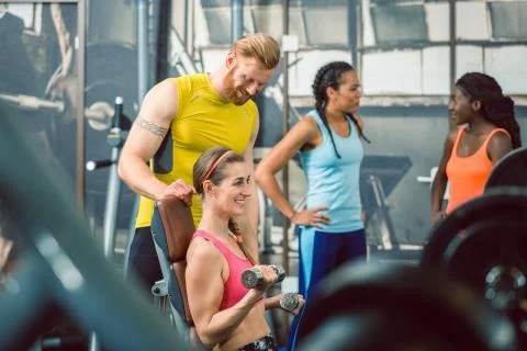 Side view of a handsome personal trainer guiding his client Stock Photos