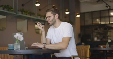Side view of handsome serious man in eyeglasses wearing in white shirt sitting Stock Footage 164714839