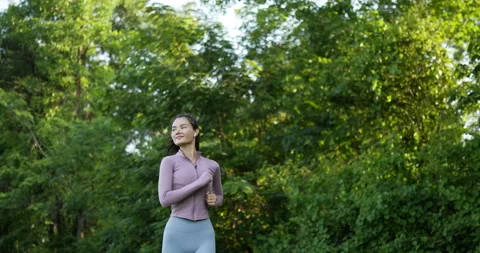 Side view of Happy asian young woman running and exercising in a park outdoor Stockbeeldmateriaal 201507701