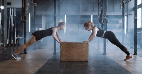 Side view happy attractive young blonde woman working out with personal female Stock Footage 116881108