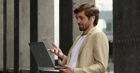 Side view of happy bearded man in formal suit standing outdoors with opened Stock Footage 137744191