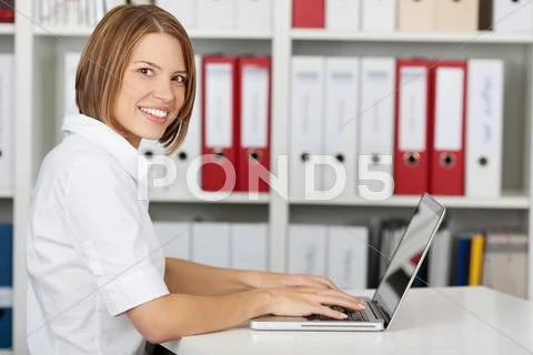 Side view of happy businesswoman with laptop Stock Photos
