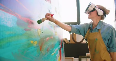 Side view of happy Caucasian young female painter working on abstract painting Stock Footage 149574953
