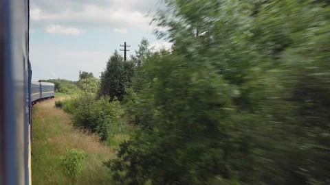 Side view of high-speed turning train on landscape of beautiful nature wild Stock Footage 157562899