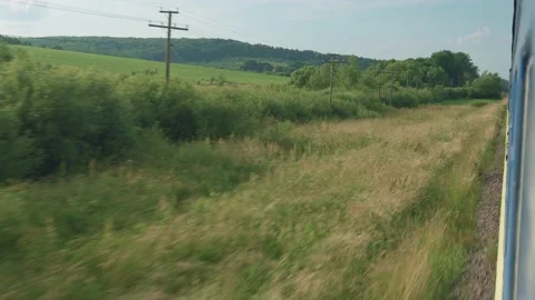 Side view of high-speed turning train on landscape of beautiful nature wild Stock Footage 157563013