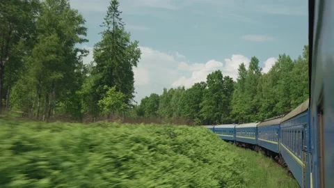 Side view of high-speed turning train on landscape of beautiful nature wild Stock Footage 157698245