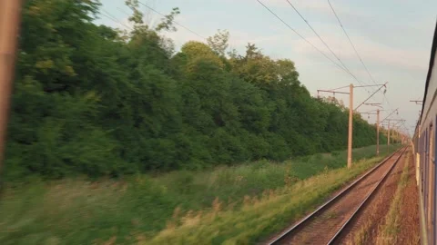Side view of high-speed turning train on landscape of beautiful nature wild Stock Footage 157889363