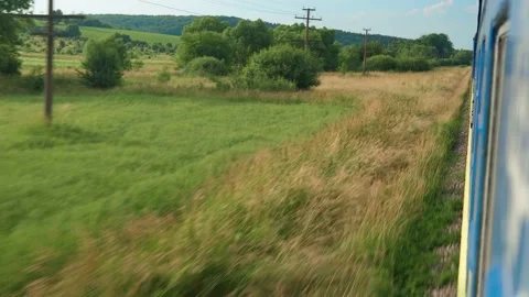 Side view of high-speed turning train on landscape of beautiful nature wild Stock Footage 161600683