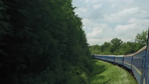 Side view of high-speed turning train on landscape of beautiful nature wild Stock Footage 167324114