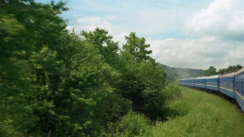 Side view of high-speed turning train on landscape of beautiful nature wild Stock Footage 198258609