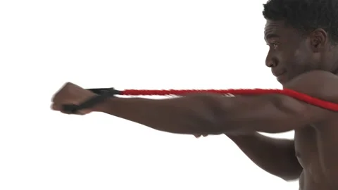 Side view of a highly concentrated African fighter practicing punches with Stock-Footage 133782074