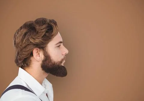 Side view of hipster with beard over brown background Stock Photos