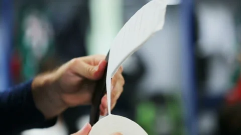 Side view hockey player winds white tape to black stick Stock Footage 93882802