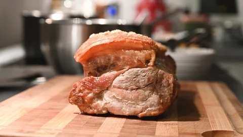 Side view of hot crispy roast pork placed on a cutting board Stock Footage 116229512