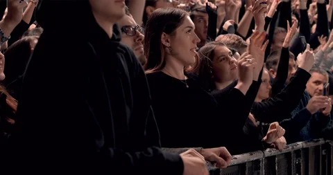 Side view huge crowd jumping and cheering at a concert or a show Stock Footage 125624698