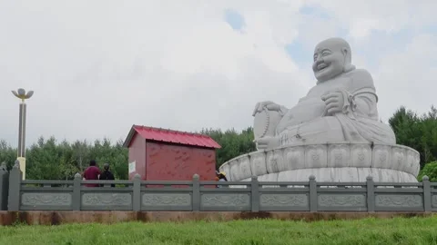 Side view of Huge Maitreya Buddha Statue at Wutai Shan Buddhist Garden, Canada Stock Footage 278012637