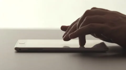 SIDE VIEW: A human hands touching on a tablet PC on a desk Vídeo Stock 66786649