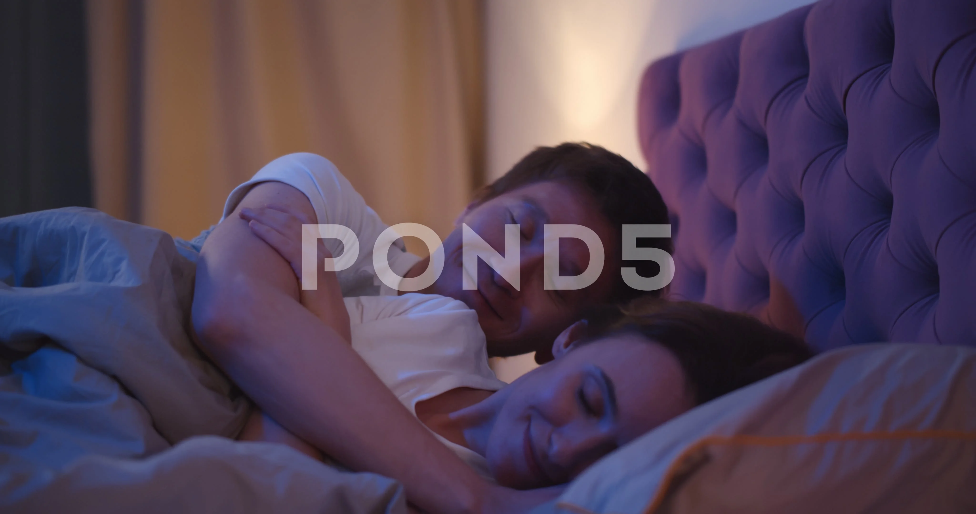 Side view of husband kissing and hugging wife falling asleep together in image