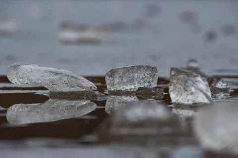 Side view of ice block laying on ice surface Stock Photos