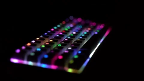 Side view of illuminated RGB keyboard in the dark Stock Footage 150978796