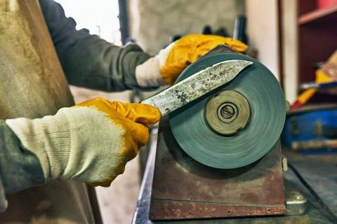 Side view image of adult man manufacturing in his workshop. Worker man sharpe Stock Photos