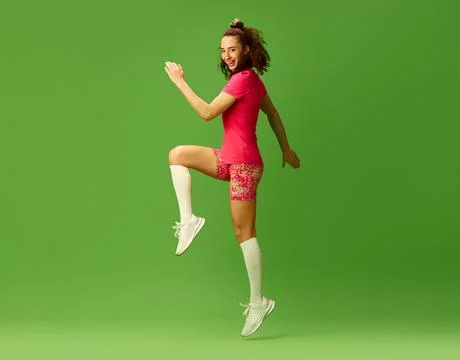 Side view image of athletic fit young girl training in colorful sportswear Stock Photos