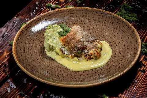 This side view image showcases a dish with fish, mashed potatoes, asparagus a Stock Photos