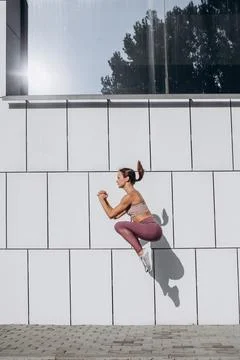 Side view image of young slim sportive caucasian woman working out, doing Stock Photos