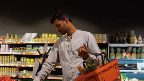 Side view of indian man buying pepper in supermarket Stock Footage 251825334