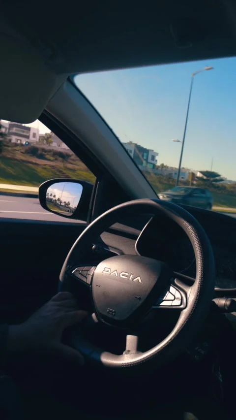 Side view from inside the car - Driver's hand controlling the Dacia car Stock Footage 303967487