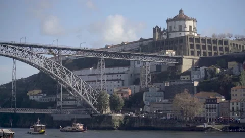 Side view of the iron bridge structure overlooking the river and the city. Stock Footage 327624546