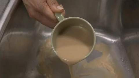 Side view-italian coffee maker pouring tea in the sink 4k Stock Footage 96138915