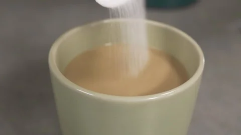 Side view-italian coffee maker pouring sugar in to coffee cup 4k. Stock Footage 96146275
